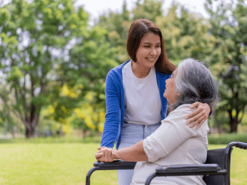a senior lady in wheelchair gets homecare help and is grateful to her homecare giver