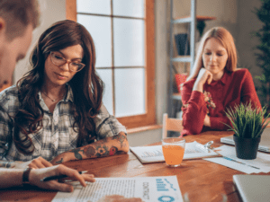 young home caregivers sit together and make a plan of their homecare work