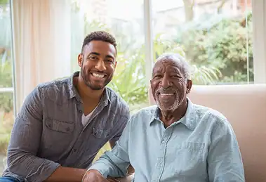 Senior man with caregiver smiling. Home care in Bucks County provides compassionate support.