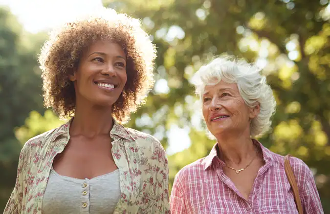 Woman and senior mother walking outdoors. Home Care Lehigh Valley support.